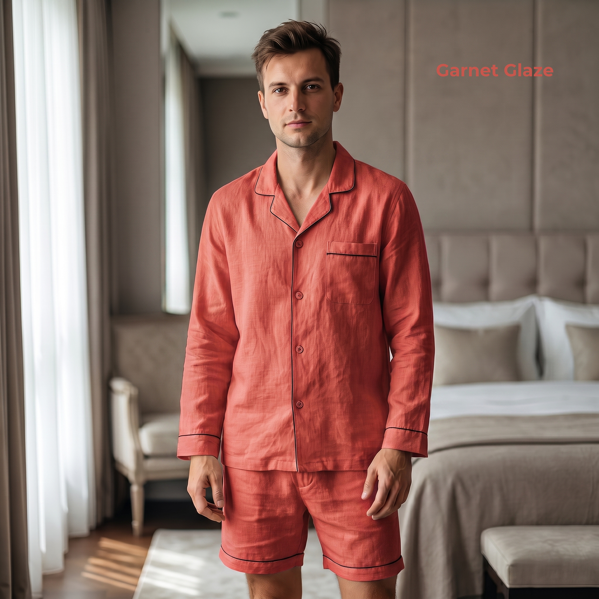 Man wearing coral pajamas standing in a bedroom