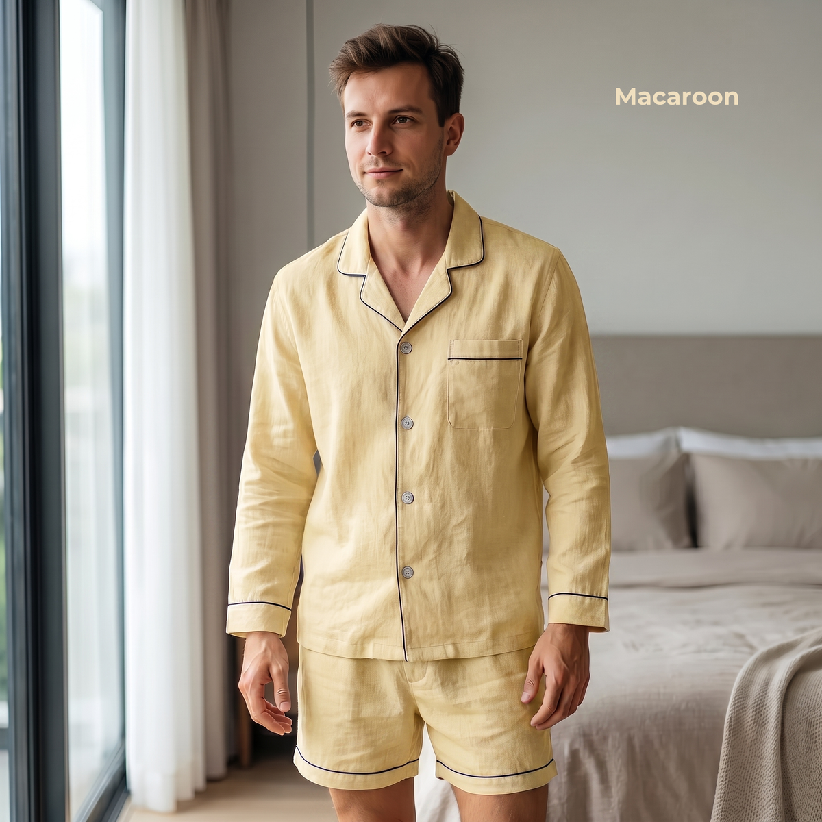 Man wearing a beige pajama set standing in a bedroom with 'Macaroon' branding.