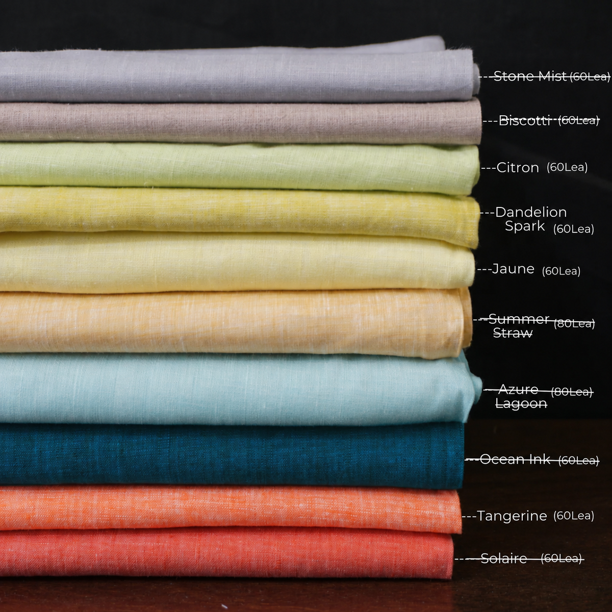 Stack of folded fabric swatches in various colors with labels on a dark background