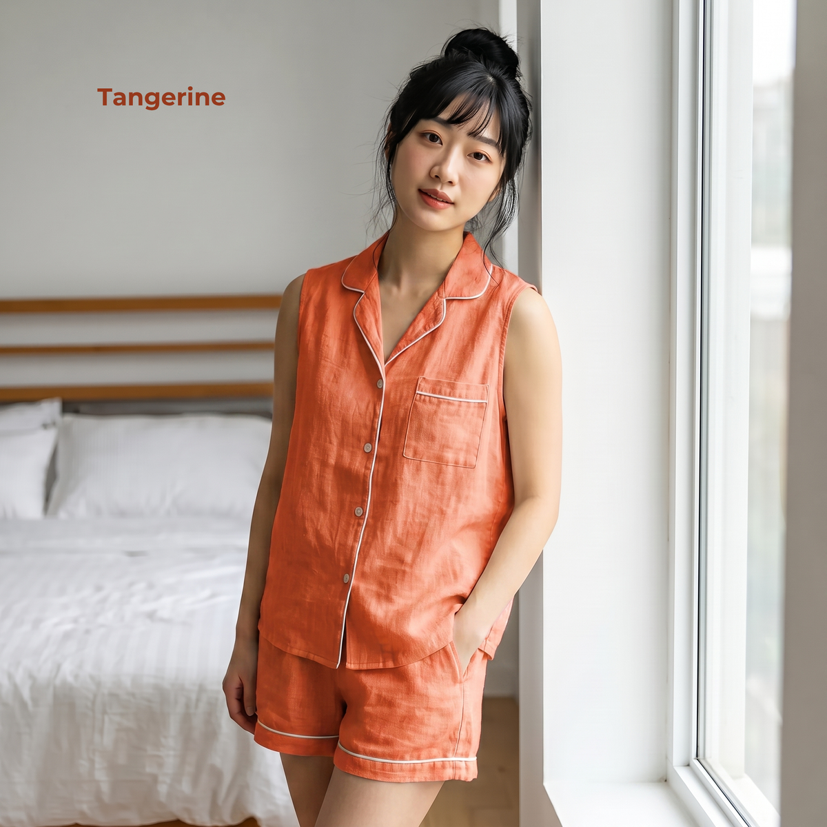 Woman wearing an orange pajama set in a bedroom with 'Tangerine' text.